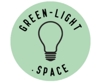 This is the logo, featuring a light bulb in the middle, surrounded by the text "green-light.space," which marks the name of the website. A green circle background frames all of it.